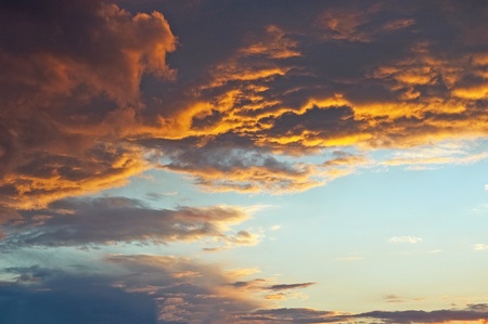 A horizontal shot of bright blue sky with puffy white clouds.