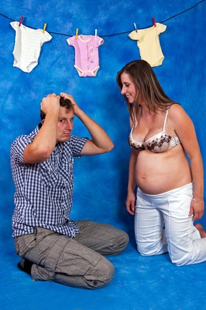 pregnant woman to her husband explaining how it will be after the birth in the blue mosaic backgroundの写真素材
