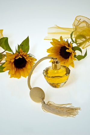 Sunflowers perfume bottle with white gray shaded backgroundの写真素材