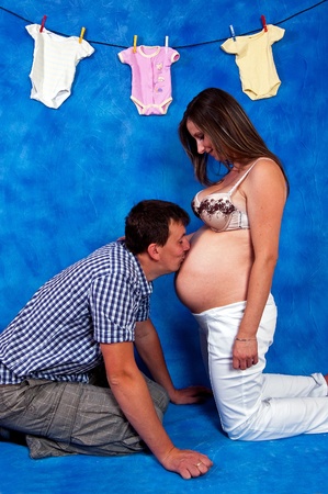 pregnant woman and her prtner greeted with yet unborn daughterの写真素材