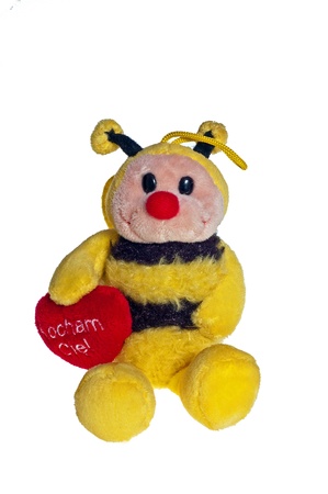 Plush bee with a heart for all the love on a white backgroundの写真素材