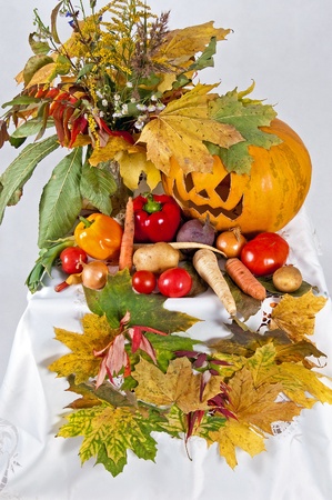 autumn composition of vegetables of leaves and the pumpkin halloween on the white backgroundの写真素材