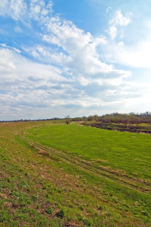 River embankment that separates the river from the rural infrastructureの写真素材