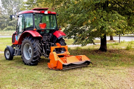 Tractor mowing grass on the lawn housing estateの写真素材