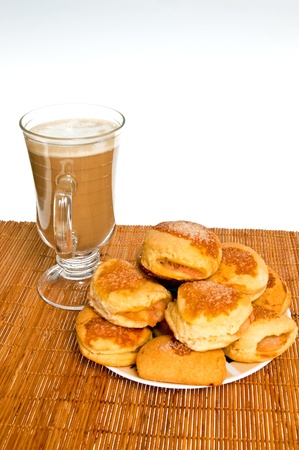 Shortbread cookies with apples and coffee for breakfast standing on a bamboo mat and white backgroundの写真素材