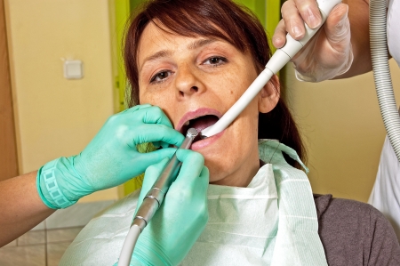Dental treatment in a young woman in a dentist's officeの写真素材