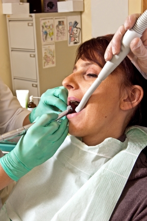 Dental treatment in a young woman in a dentist's officeの写真素材