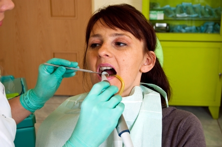 Dental treatment in a young woman in a dentist's officeの写真素材