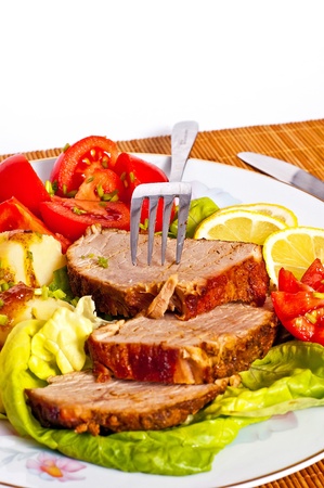 Roast with vegetables on a white backgroundの写真素材