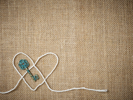 Valentines day love background on textile with a key to the hearの写真素材