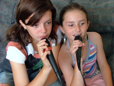 2 beautiful girls singing karaokeの写真素材