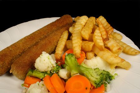 Crumbed sausages chips and vegetablesの写真素材