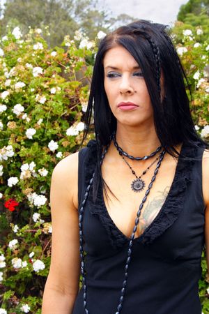 beautiful woman in a black formal dress with tattoo on breastの写真素材
