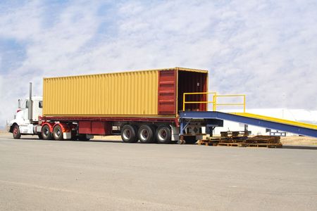 large semi truck backed onto loading dock
