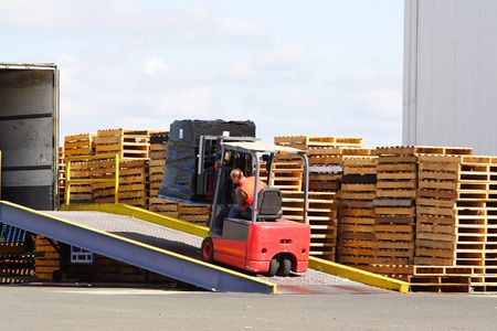 Forklift driver loading truckの写真素材