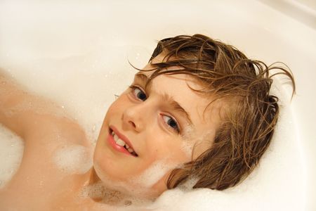 Cute boy in bubble bath