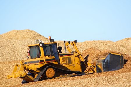 Large earthmover with scoop of wood chipsの写真素材
