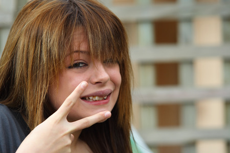 Beautiful girl with peace signの写真素材