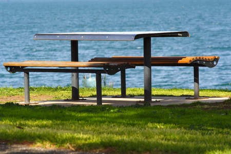 Picnic table by the seaの写真素材