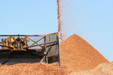 Large earthmover with scoop of wood chipsの写真素材