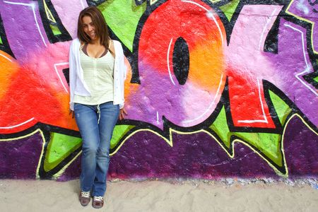 Beautiful Colombian woman with graffiti background の写真素材