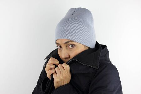 A woman wearing a heavy jacket and beanie for winterの写真素材