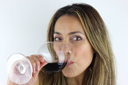 Beautiful Colombian woman with a glass of red wineの写真素材