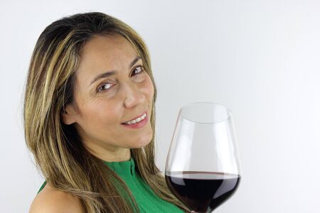 Beautiful Latin American Woman with a glass of red Wineの写真素材