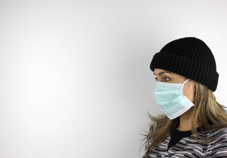 Latin American woman wearing a virus mask for the prevention of the corona virusの写真素材