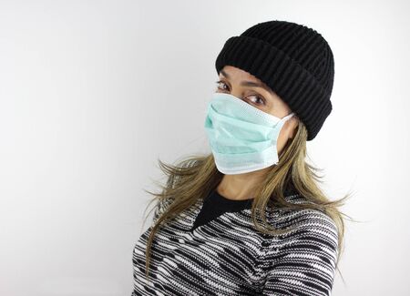Latin American woman wearing a virus mask for the prevention of the corona virusの写真素材