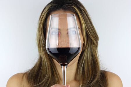 Beautiful Latin American Woman with a glass of red Wineの写真素材