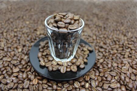 Dark roasted coffee beans in a piccolo cupの写真素材