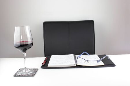 Working from home with a glass of wineの写真素材