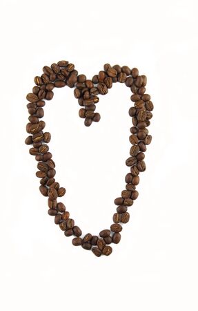 Love heart made with dark roasted coffee beansの写真素材