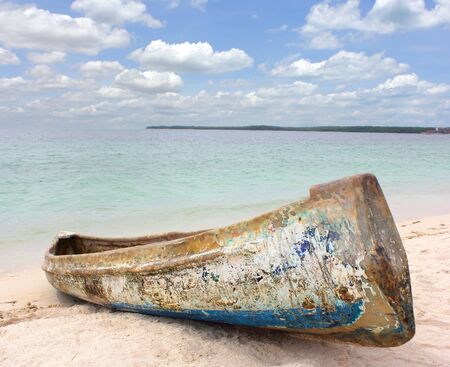 Abandoned boat washed up on the sandの写真素材