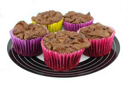 Plate of home made chocolate chip cup cakesの写真素材