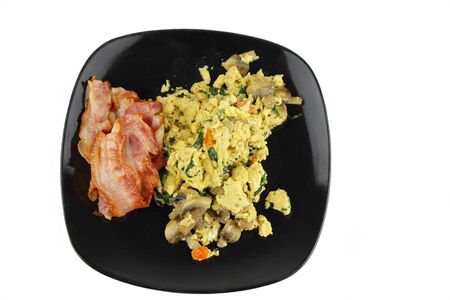 Scramble egg and bacon with a white backgroundの写真素材