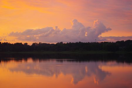 The bright, saturated setting on lake at calm and in silence.の写真素材