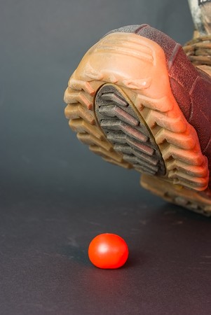 The person is going to crush a boot small tomatoesの写真素材