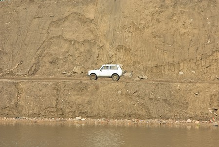 The car against huge weight of sandの写真素材
