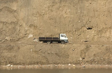 The car against huge weight of sandの写真素材