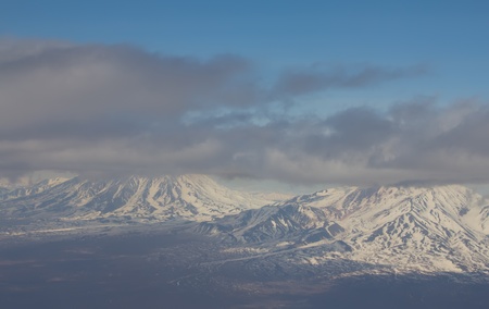 Kamchatka from height of bird's flight. Volcanoes in clouds.の写真素材