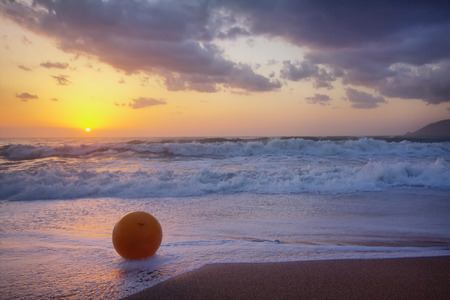 Gentle warm sea on backdrop of enchanting sunset. Foamy surf. Mediterranean sea.の写真素材