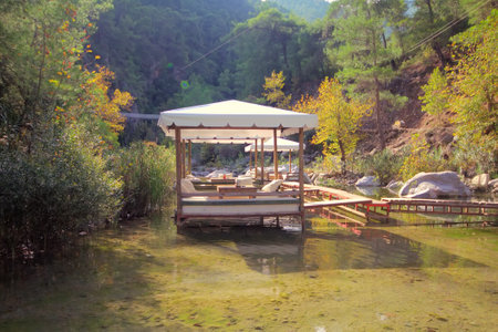 Tables of  restaurant are among  pure river in  mountains. Clear water and reflection.のeditorial素材