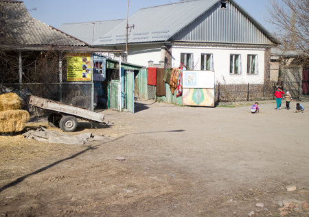 Kazakhstan, Kulan - February 27, 2016: usual private house with a yard and children playingのeditorial素材