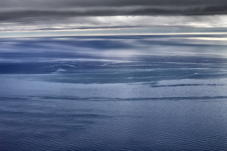 Global warming. Arctic ocean from height of bird flight - free of ice. calm, visible shafts of ocean...