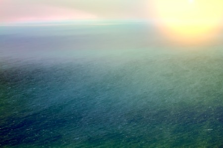 Global warming. Arctic ocean from height of bird flight - free of ice. Setting sun, storm, are specific foam streaks downwind. HDR filter, view from helicopterの写真素材