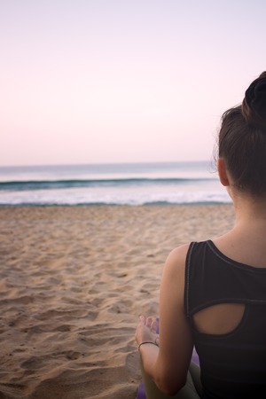 meditation on beach girls yoga trainer at home yoga. Lotus and sea in early morning