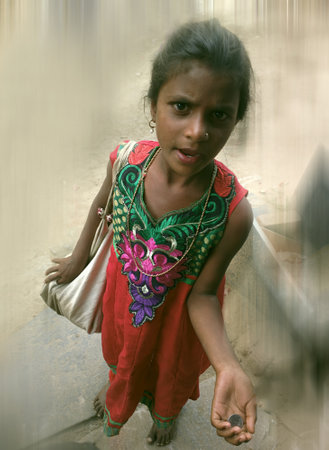 India, Anantapur - February 1, 2016: Beautiful mendicant. Slogan: Paragon does't spoil even hardship. Slender youth: necklaces, earrings, pin in nostrilのeditorial素材