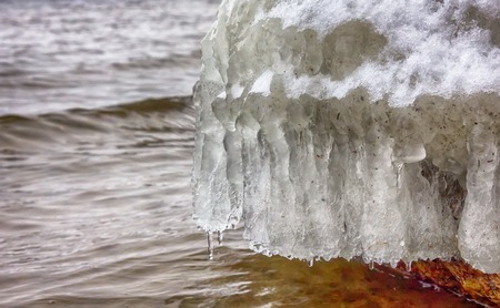 frozen coast sea in winter. water and ice in cold weather when seasons changeの写真素材